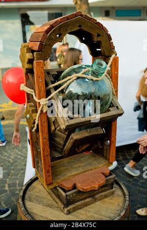 Vinnytsia Ukraine - September 09, 2017: Birthday of the city of Vinnytsia. A large glass bottle in a wooden frame. Stock Photo