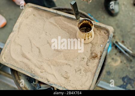 https://l450v.alamy.com/450v/2b4x7e4/close-up-view-of-turkish-coffee-prepared-on-hot-golden-sand-2b4x7e4.jpg