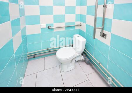 Interior of specially adapted bathroom toilet with friendly design for people with disability handicapped with disabilities or invalids in wheelchair Stock Photo