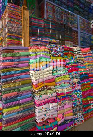 Stacks of Colorful Fabrics for sale in the wear-house Stock Photo