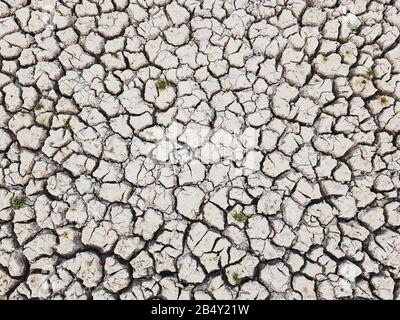 Details of a dried cracked earth soil ground background. Stock Photo
