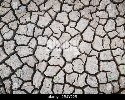 Details of a dried cracked earth soil ground background. Stock Photo