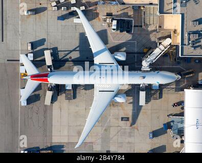 American Airlines Boeing 777 wide body long haul jetliner parked at Los Angeles, USA International Airport terminal with jet bridge. 777-300 N726AN. Stock Photo