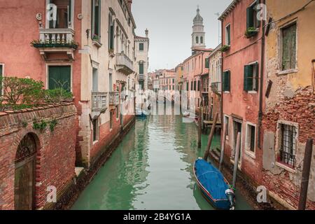 Old houses and apartments line a canal in the residential district of Venice, Italy Stock Photo