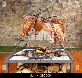 Asado roast barbecue meat on fire, traditional dish in Argentina, Uruguay, Paraguay, Chile, and Brazil Stock Photo