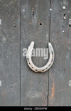 Horseshoe isolated on wooden boards Stock Photo