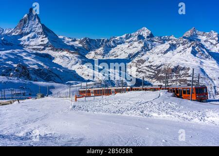 Matterhorn peak with a train in Swiss Alps, Switzerland Stock Photo