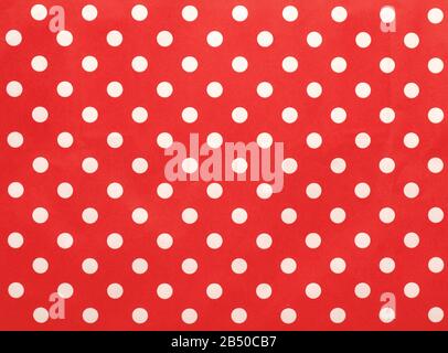 Paper texture with white dots on a red background, Christmas or seasonal background, high resolution Stock Photo