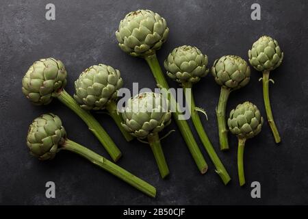 Fresh green artichokes on black background Stock Photo
