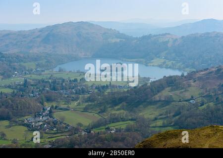 Grasmere village and lake and Loughrigg Fell in the background, seen from the summit of Helm Crag, Grasmere, Lake District National Park, Cumbria, UK Stock Photo