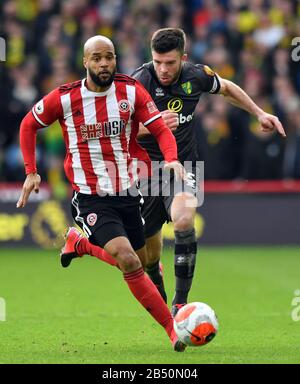 Norwich City's Grant Hanley (right) and Sheffield United's David McGoldrick battle for the ball during the Premier League match at Bramall Lane, Sheffield. Stock Photo