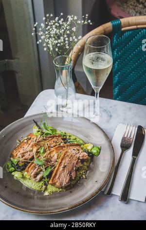 Pork Belly In Pipian Verde 14 hour slow cooked pork belly with crunchy skin, pumpkin seeds and green tomatillos salsa. Stock Photo