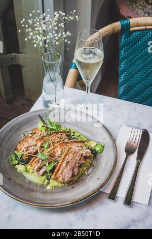 Pork Belly In Pipian Verde 14 hour slow cooked pork belly with crunchy skin, pumpkin seeds and green tomatillos salsa. Stock Photo