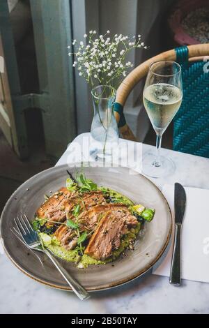 Pork Belly In Pipian Verde 14 hour slow cooked pork belly with crunchy skin, pumpkin seeds and green tomatillos salsa. Stock Photo