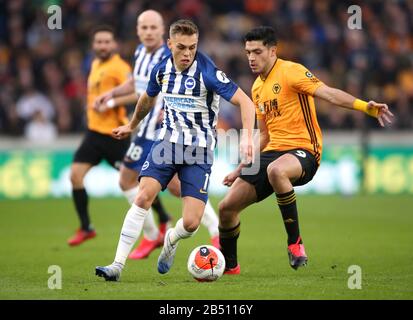 Brighton and Hove Albion's Leandro Trossard (left) and Wolverhampton Wanderers' Raul Jimenez battle for the ball during the Premier League match at Molineux, Wolverhampton. Stock Photo