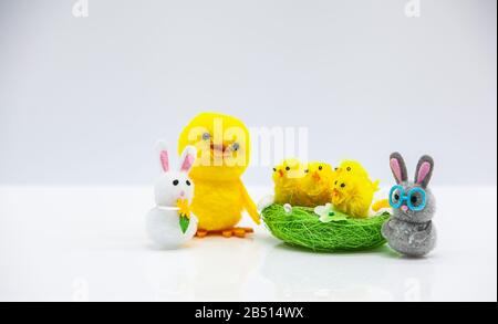 happy easter scene with yellow fluffy chicks in a basket  and bunnies Stock Photo