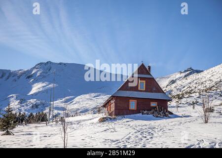 Stunning wooden cottage in Gasienicowa valley at winter Stock Photo