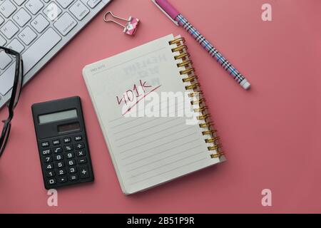 401k text on notepad with coins and keyboard on table  Stock Photo