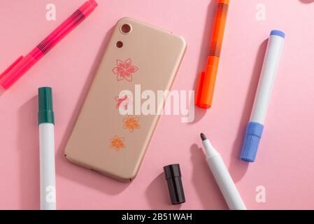 Beautiful flower art drawn on beige phone case Stock Photo