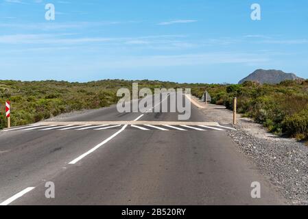 Cape Point, Western Cape, South Africa. 2019.  Quiet highway with a speed bump approaching Cape Point in the Table Mountain National Park, S Africa Stock Photo