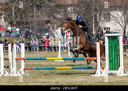 Sofia, Bulgaria - March 03, 2020: Equestrian Easter or Todor Day in Bulgaria, policemen riding horses on the holiday. Jumping on horseback. Stock Photo