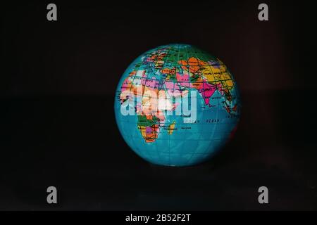 Multicolored globe isolated on a dark background. Stock Photo