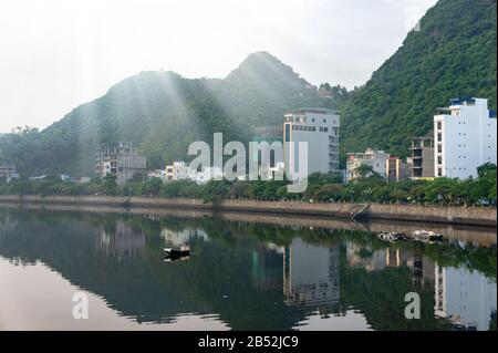 Cat Ba island, Vietnam Oct 17, 2019. Beautiful lake, reflection buildings in the water. Quiet district. foggy dawn Stock Photo