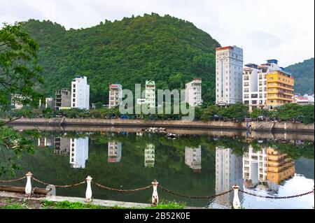 Cat Ba island, Vietnam Oct 17, 2019. Beautiful lake, reflection buildings in the water. Quiet district. Stock Photo