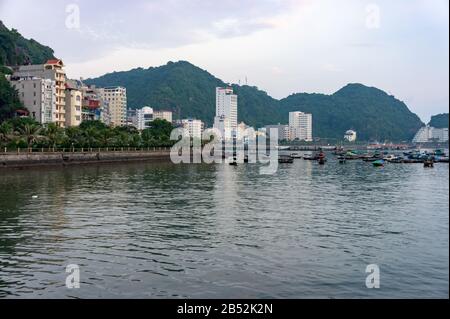 Cat Ba island, Vietnam Oct 17, 2019. fishing small boats in the bay. View of the main street with the hotels of Cat Ba Stock Photo