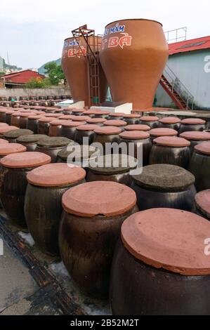 Cat Ba island, Vietnam Oct 17, 2019. Big jars in production of fish sauce in Vietnam. Factory fish sauce production facilities on Cat Ba island. Many Stock Photo