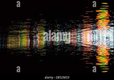 Water texture with color reflections on a black background Stock Photo