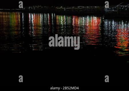 Water texture with color reflections on a black background Stock Photo