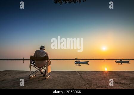 Weekend Old man fishing in Dammam Sea side Saudi Arabia. Stock Photo