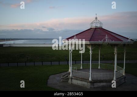ST ANDREWS, SCOTLAND - 2/3/2020 - A view of the bandstand behind the Old Course, with the sea off West Sands in the background, at dusk Stock Photo