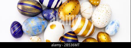 Easter Banner.Many easter eggs trendy colored classic blue, white and golden on white. top view, flatlay, copy space. Stock Photo