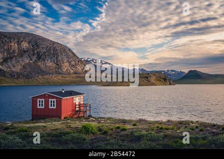 Red shelter on a lakeside on the Arctic Circle Trail, Greenland --- NIKON D7500 & 17.0-70.0 mm f/2.8-4.0: 17 m Stock Photo
