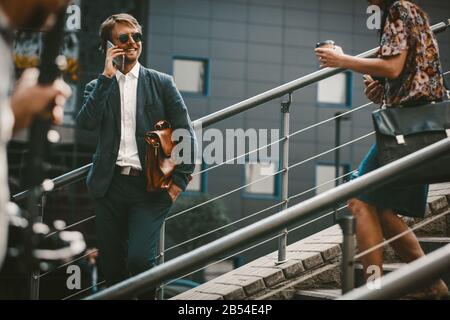 Businessman talking on the phone outdoors Stock Photo