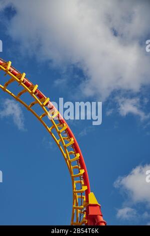 part of a roller coaster against blue cloudy sky Stock Photo