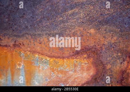 Rusty metal background with streaks of rust. The metal surface rusted spots. Stock Photo