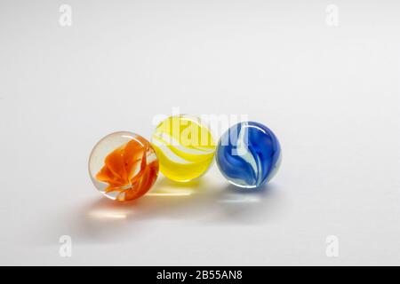 Colourful toy marbles against a white background Stock Photo