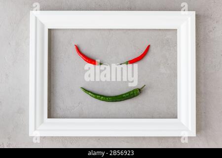 Creative image of  in white frame on concrete background, flat lay. Spicy vegetables. Stock Photo