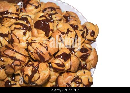 Chocolate poured eclairs isolated on white background. Stock Photo