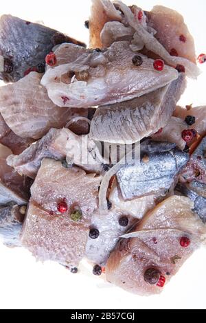 Pieces of herring on an isolated studio background Stock Photo