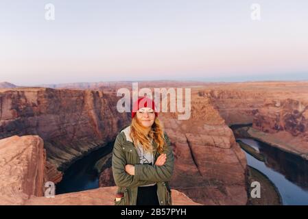 girl on Horseshoe Bend in Glen Canyon National Recreation Area in early dawn Stock Photo