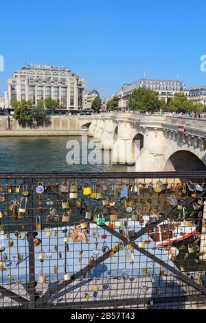Love locks and Pont Neuf. Attaching locks to bridge railings is popular with tourists but is being discouraged to improve appearance. Stock Photo