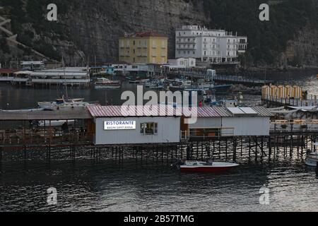 The port of Marina Grande at dusk. This ancient gateway to the city now contains numerous restaurants for tourists. Stock Photo