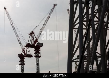 Silhouettes of tower cranes at the site of Tokyo Sky Tree under construction. Oshiage, Tokyo, Japan Stock Photo