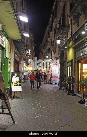 Tourists on Via San Cesareo in downtown Sorrento, Italy at night. This pedestrian shopping street is a popular destination. Stock Photo