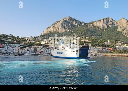 Caremar ferry Naiade arriving at Marina Grande on the isle of Capri. Ferries provide transport of passengers and vehicles. Stock Photo