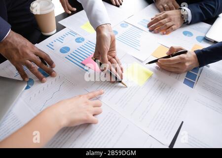 Top view of diverse businesspeople discuss financial documents Stock Photo